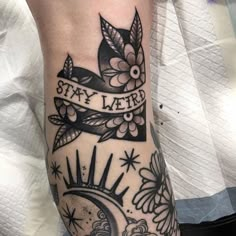 a black and white tattoo on the arm with an inscription saying stay weird above it