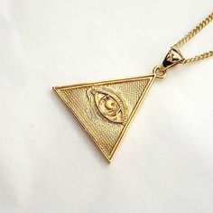 women's and men's triangle the Eye of Providence necklace pendant 2 made in 14k solid gold or 18k solid gold the eye of providence with exquisite details is on a triangle pendant. the Eye of Providence is a symbol that depicts an eye, meant to represent divine providence, whereby the eye of God watches over humanity. - this pendant height is 25.5mm without the bail. - model wears a 1.7mm 50cm chain. - materials: real 14k solid gold, real 18k solid gold - designed by carre d'or - made in South Korea 14k gold pendant necklace weight pendant only 3.94g (±3%) with a 1.4mm 42cm chain 6.80g (±3%) with a 1.7mm 42cm chain 8.02g (±3%) with a 2.1mm 42cm chain 9.90g (±3%) 18k gold pendant necklace weight pendant only 4.70g (±3%) with a 1.4mm 42cm chain 8.11g (±3%) with a 1.7mm 42cm chain 9.51g (±3%) Triangle Yellow Gold 14k Jewelry, 14k Gold Triangle Jewelry In Gold Color, 14k Gold Triangle Jewelry, 14k Gold Triangle Shaped Jewelry, Triangle Eye, Gold Necklace Pendant, Divine Providence, Eye Of Providence, Mens Necklace Pendant