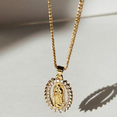 We celebrate the goodness of Mother Mary in big and small ways. The Empowered Mother Mary Necklace is a sentimental and stylish statement necklace. Featuring her beautiful CZ design and the strength she possesses all in one necklace. Product Details: 18" 14k Gold-Filled Baby Curb Chain 30mm CZ Mother Mary Charm Not Water-Wearable Made in Scottsdale, AZ Blessed Mother Necklace, Mother Mary Necklace Gold, Virgin Mary Pendant Necklace As Gift, Virgin Mary Pendant Jewelry Gift, Gold Virgin Mary Pendant Necklace, Mother Mary, Solid Gold Jewelry, Base Metal, Gold Filled Jewelry