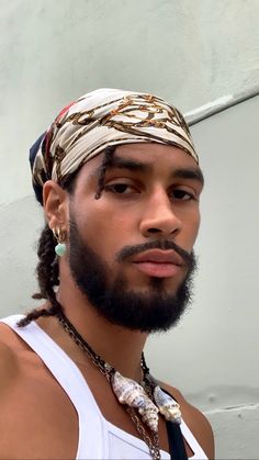 a man wearing a bandana with braids on his head