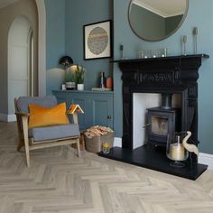 a living room filled with furniture and a fire place in front of a mirror on the wall