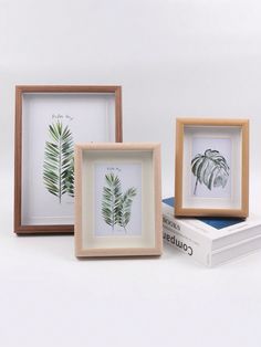 three framed pictures sitting next to each other