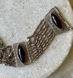 "Beautiful Silver Filigree Open Back Purple Amethyst Marquis Cabachon Vintage Bracelet The bracelet measures just under 7\" long and aprox 1 inch wide Pictures dont show color well, stone are a beautiful open back setting see matching necklace in link below https://www.etsy.com/listing/1049611046/beautiful-silver-filigree-bib-festoon?ref=shop_home_active_1&frs=1" Luxury Silver Bracelets With Cabochon, Purple Bohemian Jewelry For Formal Occasions, Vintage Silver Amethyst Bracelets, Formal Bohemian Purple Jewelry, Wide Pictures, Usa Jewelry, Vintage Bracelet, Handcrafted Necklace, Silver Filigree