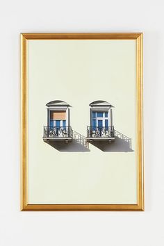 two framed photographs of people sitting at the top of a building with their shadows on the wall