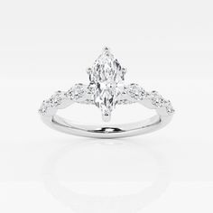 a white gold ring with a pear shaped diamond