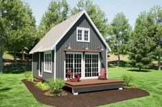 a small gray house sitting on top of a lush green field