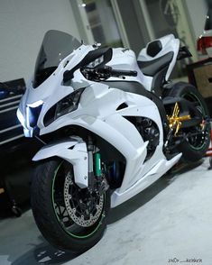 a white and black motorcycle parked in a garage