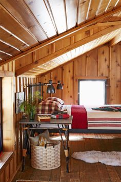 a bedroom with wood paneling and exposed ceiling