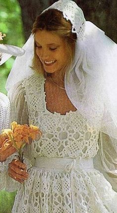 two women in wedding dresses and veils holding flowers