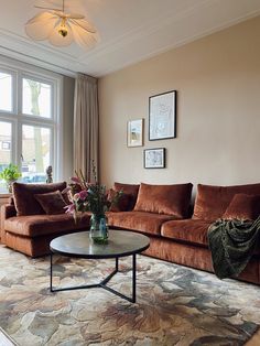 a living room filled with furniture and a large window