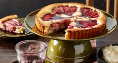 a strawberry pie on a plate with one slice cut out and another piece missing from it