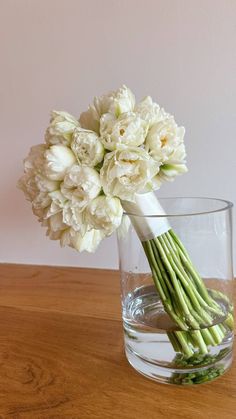 a bouquet of white flowers in a glass vase