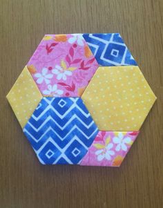 an origami hexagonal piece on a wooden table