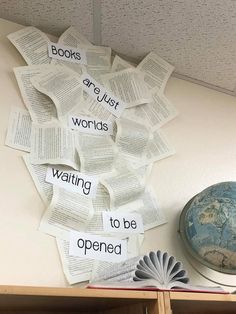 an open book on top of a desk next to a globe