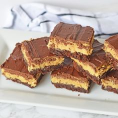 chocolate and peanut butter squares on a white plate