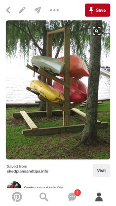 several canoes are stacked up on a wooden stand