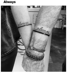 two people holding hands with tattoos on their arms and wristbands that say always