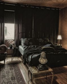 a large bed sitting next to a window in a bedroom on top of a wooden floor