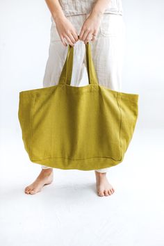 a woman holding a green bag in her hands