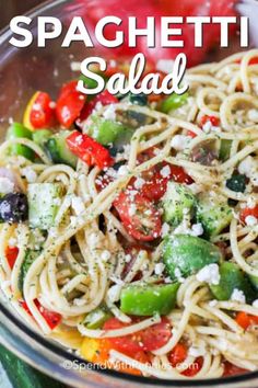 a glass bowl filled with pasta and vegetables