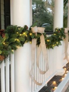 christmas garland with lights on the front porch