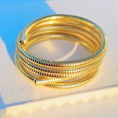 Spiral Stretch Bracelet Gold Snake Chain Bracelet As Gift, Gold Snake Chain Bracelet For Gift, Flexible Gold-plated Bracelets, Gold Flexible Slinky Bracelet, Adjustable Gold Slinky Bracelets, Gold Stackable Stainless Steel Bracelets, Modern Gold Bracelet In Snake Chain Style, Adjustable Yellow Gold Stainless Steel Bangle, Gold Stainless Steel Stackable Bracelets