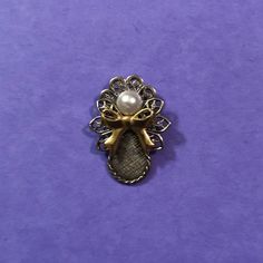 "This little beauty is available in four finishes. Bright gold, bright silver, antique gold, and antique silver with a contrasting bow with a pearl head. Size: 1 1/8\"x 3/4\"" Elegant Metal Brooches As Gift, Gold Jewelry With Decorative Bow For Wedding, Elegant Brass Brooch For Gift, Vintage Jewelry With Decorative Bow As Gift, Vintage Gold Jewelry With Ribbon, Elegant Gold Metal Brooches, Elegant Gold Brooches With Ribbon, Angel Pins Jewelry, Vintage Gold Jewelry With Decorative Bow