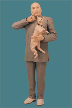 a statue of a man holding a cat on his shoulder and pointing to the side