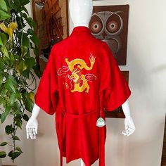 Cross posted and in my vintage booth.  Item may not be available if sold elsewhere. If not available, I will refund you promptly. Thank you for understanding!  Gorgeous red silk robe with dragon embroidery.  Unworn with original tags.  Great for warmer months. Makes a wonderful gift!   DETAILS: Excellent Condition  70s to 80s Era 100% silk, lightweight Solid red with floral design  Short wide sleeves Belt loops and belt Two pockets with "cloud" embroidery Hits at knee Back has yellow embroidered dragon Unlined **robe has not been washed due to new condition **small spot at neckline, should come out with dry cleaning LABEL:  Health Shanghai China, M  Paper tag attached MEASUREMENTS: Dropped Shoulder: 26" Sleeves:   9-1/2" Bust:  up to 46" Waist:  up to 44" Hem:  up to 46"  Total length:  35 Red Silk Robe, Cloud Embroidery, Vintage Booth, Embroidered Dragon, Dragon Embroidery, 80s Era, Silk Robe, Shanghai China, Solid Red