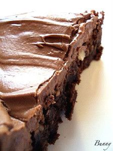 a piece of chocolate cake sitting on top of a white plate