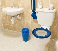 a bathroom with a toilet, sink and bidet in it's corner area