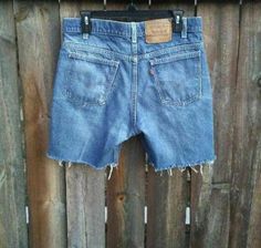 "ASK ALL QUESTIONS BEFORE PURCHASING. CLICK ON \"SHIPPING & POLICIES\", FOR SHIPPING INFO., ETC. This is a pair of Levi's \"517\" jeans with an orange tab, customized into a pair of cut-off shorts. Featuring a distressed style. Blue jean, raw & frayed bottom. Zipper & single button closure. Pre-owned & in good worn-in condition. SIZE: No inside tag but the outside brown tag says \"W 34\" (waist: 34)   (See measurements below). MATERIAL: No material tag but in my opinion they look 100% Cotton (re 90s Style Cutoff Bottoms For Streetwear, Grunge Jean Shorts With Pockets, Grunge Cutoff Bottoms With Frayed Hem, Casual Festival Jeans, High Waist Denim Bottoms For Concert, Retro Ripped Medium Wash Bottoms, Punk Style Short Bottoms For Festival, Medium Wash Frayed Hem Grunge Bottoms, Medium Wash Grunge Bottoms With Frayed Hem