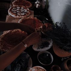 a table topped with lots of pies and bowls filled with different types of food