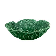 a green cabbage leaf bowl on a white background