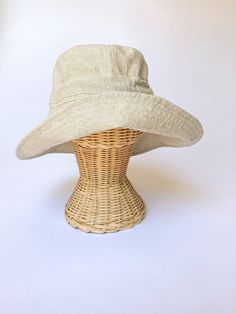 "A sun hat for beach days and summer fun. This sun hat for women has a nice wide brim to protect your whole face and even your neck and chest. A drawstring around the head keeps the hat fitting snug. Easy to bring along in your bag, folds up easy. This hat is made from a medium weight homespun linen and cotton blend fabric in a neutral beige color. Inside liner is white cotton. I used a stiff interfacing for brim to keep it's shape. Brim measures 4.5\" Crown depth is 3.5\". Contact me for custom Lightweight Wide Brim Sun Hat, One Size Fits Most, Adjustable Brimmed Bucket Hat For Beach Season, Lightweight Wide Brim Sun Hat For Beach Season, Wide-brim Lightweight Hat For Beach Season, Lightweight Wide Brim Hat For Beach Season, Beige Summer Bucket Hat With Uv Protection, Lightweight Wide Brim Sun Hat For Beach, Lightweight Solid Color Sun Hat For Summer, Adjustable Wide Brim Bucket Hat With Upf 50+