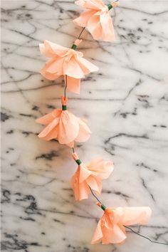 some pink flowers are on a marble table