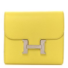 This is an authentic HERMES Epsom Constance Short Wallet in Lime. This stunning wallet is crafted of fine epsom calfskin leather in yellow. This wallet features top flap that tucks into a prominent H in silver palladium hardware and opens to a cross grain compact partitioned yellow leather interior with card slots and a zipper pocket. Elegant Yellow Leather Wallet, Elegant Yellow Wallet, Classic Yellow Rectangular Wallet, Hermes Wallet, Hermes Accessories, Hermes Constance, Short Wallet, Yellow Leather, Leather Interior