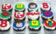 cupcakes decorated with lego characters and numbers in a plastic container on a table