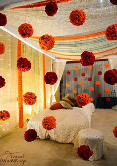 the bed is decorated with red and orange flowers