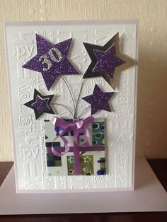 a white card with purple stars on it and the number twenty five in front of them