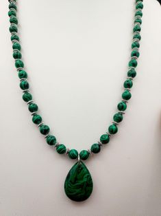 This natural Malachite Necklace is paired with small Stainless Steel spacers so you can see all the wonderful details of the stone. Please be advised not to wear this in water or it can weaken the stone.  Malachite was believed to be used in ancient Egypt as early as 3000 B.C. for jewelry and ornaments. In the Middle Ages, Malachite was used for protection of the evil eye. It opens the heart and will allow for balance on all levels. It is also associated with the element of Fire. The throat chakra governs your ability to communicate. Malachite activates this chakra to ensure that you can always speak your mind and ask for the change you need. The third eye chakra is where your deepest wisdom and powers of intuition sit. With Malachite by your side, your Third Eye is free to roam. One of it Spiritual Gemstone Teardrop Pendant Crystal Necklaces, Spiritual Teardrop Gemstone Crystal Necklace, Spiritual Gemstone Teardrop Necklace, Spiritual Teardrop Gemstone Necklaces, Spiritual Healing Necklace With Teardrop Pendant, Spiritual Teardrop Gemstone Necklace, Teardrop Pendant With Natural Stones For Meditation, Spiritual Healing Teardrop Pendant Jewelry, Spiritual Teardrop Jewelry For Healing