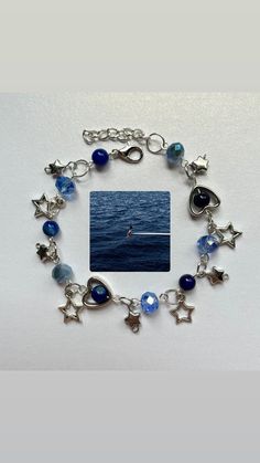 a bracelet with charms and an image of a boat in the ocean