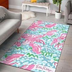 a living room area rug with pink and blue flowers on it