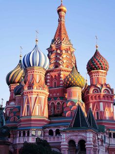 an ornate building with many domes on it's sides and blue sky in the background