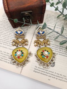 Drop earrings featuring an antique hand mirror. A beautiful handpainted flower is reflected in the mirror. Around 3.5 inches long Material brass Lightweight Antique Hand Mirror, Islamic Motifs, Jhumka Earrings, Hand Mirror, Green Tourmaline, Vintage Bags, The Mirror, Ring Bracelet, Earring Necklace