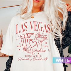 a woman wearing a white las vegas t - shirt