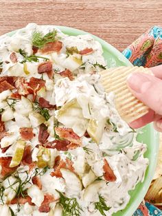 a green plate topped with potato salad and a cracker