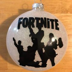 a white ornament with the words fortnite and silhouettes of people