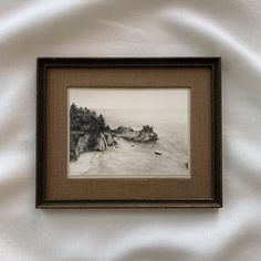 a black and white photo hanging on the side of a wall