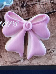 a close up of a cookie with a bow on it